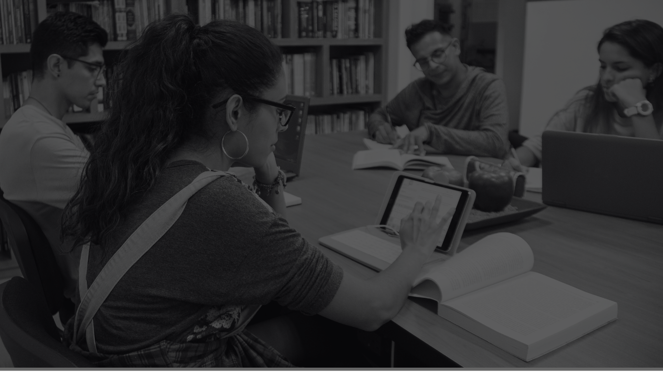 students sitting at a library table studying